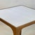 This compact side table pairs a hand-finished gilt metal frame with a luxurious goatskin-clad top, creating a refined...