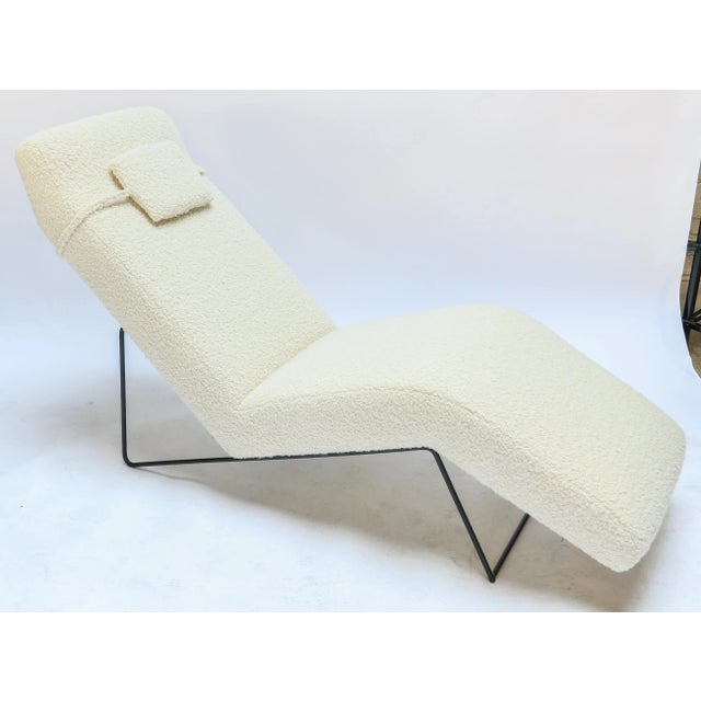 Custom mid-century style chaise longue chair with black metal frame and ivory boucle upholstery.