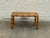 Vintage bamboo console table featuring a tightly woven rattan top and substantial bamboo frame. Thick bamboo poles with...