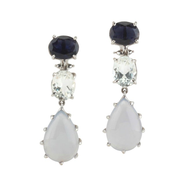 18kt white gold 3-stone drop earring with faceted iolite, faceted rock crystal, and cabochon chalcedony. Clip omega back....