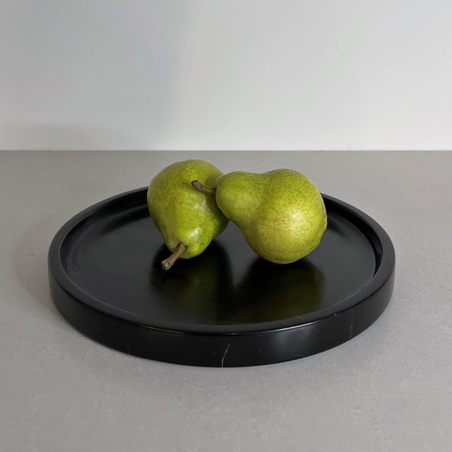 Handcrafted from richly toned black marble, the Vanda Tray is defined by its clean circular form and subtly raised edge....