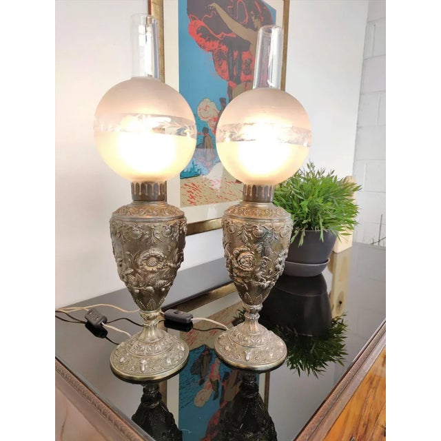 Beautiful pair of Italian table lamps in gilt bronze with the typical urn shape of oil lamps converted to electric with...