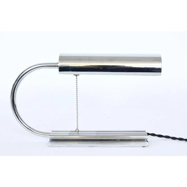 Streamline Moderne Gilbert Rohde style all chrome desk lamp. Featuring an arched Chrome plated Brass neck, rotating...