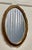 An Art Deco oval gilt wall mirror The mirror has a very attractive 2” wide gilt Frame in a Rococo style decoration. This...