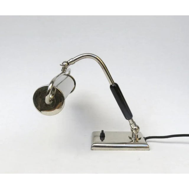 An elegant piano lamp, made in Austria, in the Art Deco period. The lamp is nickel-plated, the handle wood lacquered...