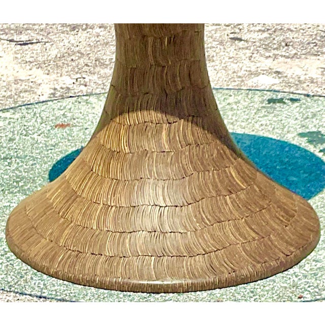 This Vintage Boho Dining Table features a striking pedestal base crafted from coconut shells, creating a unique, textured...