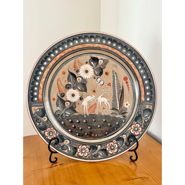 The largest we have seen, this monumental 20" Tonala earthenware charger features frolicking fawns among botanicals and...