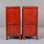 Each cabinet is constructed in softwood and finished throughout in a red-painted ground with green and gilt-outlined panel...
