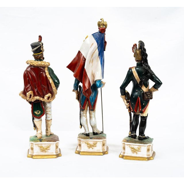 A set of three antique soldiers in polychrome Capodimonte porcelain, depicting Napoleonic soldiers, dating from the 20th...