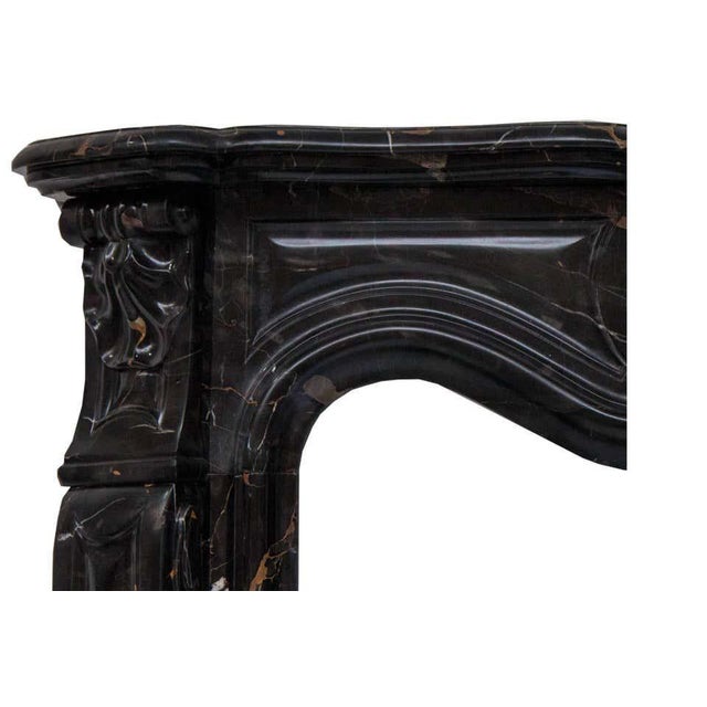 French rococo louis xv fireplace mantel made in a superb portoro marble. Hand carved molded shelf above a paneled frieze,...