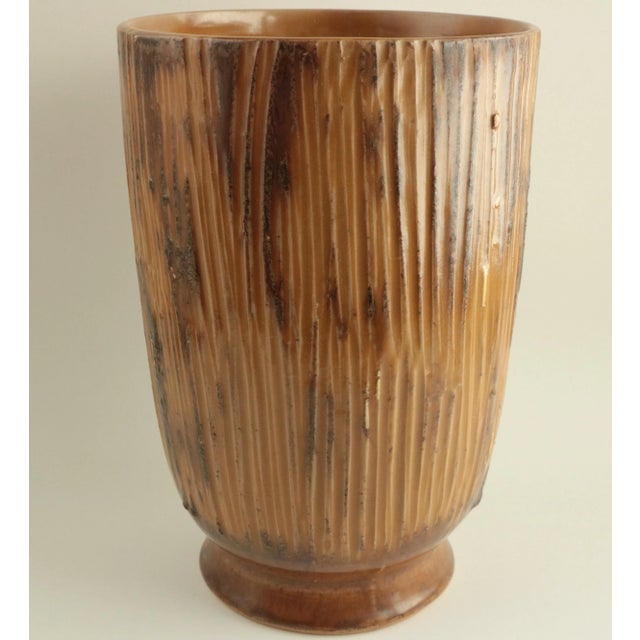 This large vintage tabletop vase is enveloped in a warm chestnut glaze and has a ribbed, heavily textured finish.