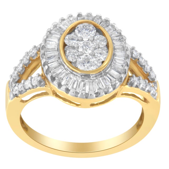 This glamorous diamond cocktail ring features a central oval cluster of round diamonds surrounded by a halo of baguette...