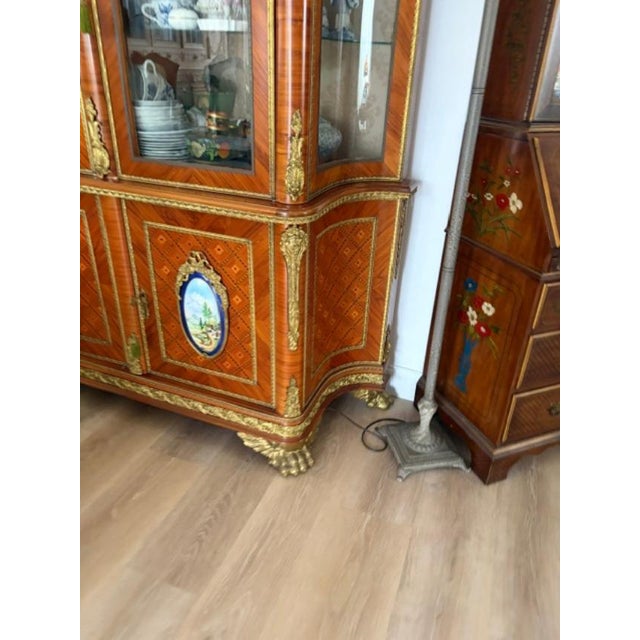 The 1960 Superb Quality Italian Display Cabinet is a beautifully crafted antique piece with intricate brass work and...