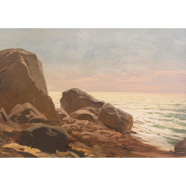 A late 19th century, American School seascape showing a lyrical view of sunlit waves flowing in towards a rocky beach. The...