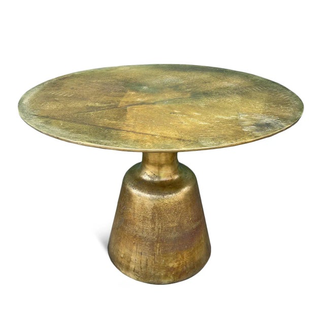 Modern round brass finish cast aluminum dining table with pedestal base. Wonderful metallic warm touch for an industrial...