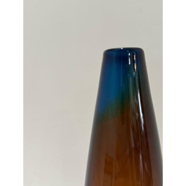 A striking signed Kosta Boda bud vase designed by renowned Swedish artist Vicke Lindstrand. This elegant piece stands 8.5"...