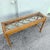 Vintage Boho Chic console table featuring an elegant faux bamboo frame with classic Chippendale-inspired details. The...