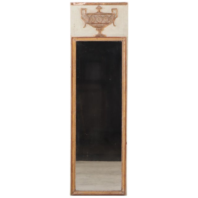 Elegant late nineteenth century French painted and gilt narrow mirror, exhibiting refined neoclassical influences and...