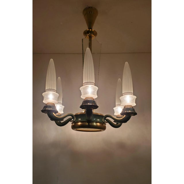 A rare French chandelier boasts six rocket-shaped glass shades on six gently curved arms, adorned with beautifully...