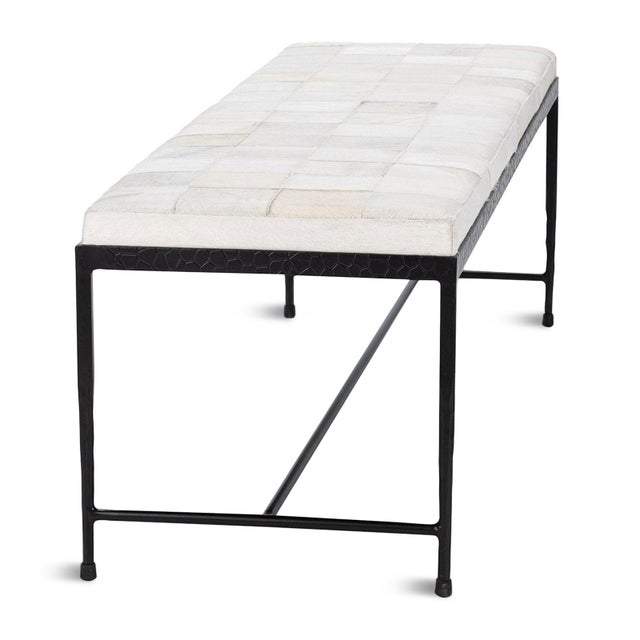 Modern beautiful ivory hide upholstered bench in a square patchwork pattern. Black iron frame/legs with organic modern...