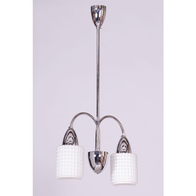 This pendant chandelier, originating from the 1960s, represents a magnificent and highly representative example of...