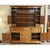This piece reflects a traditional colonial aesthetic with its warm wood finish, paneled cabinet doors, and brass hardware....