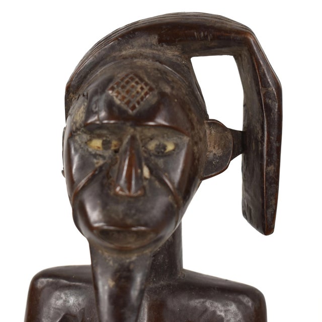 This well-carved female figure comes from the Chokwe. The Chokwe share stylistic elements with several distinct but...