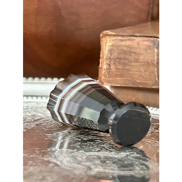 A striking French desk seal carved from richly banded agate and expertly faceted to catch the light from every angle. The...
