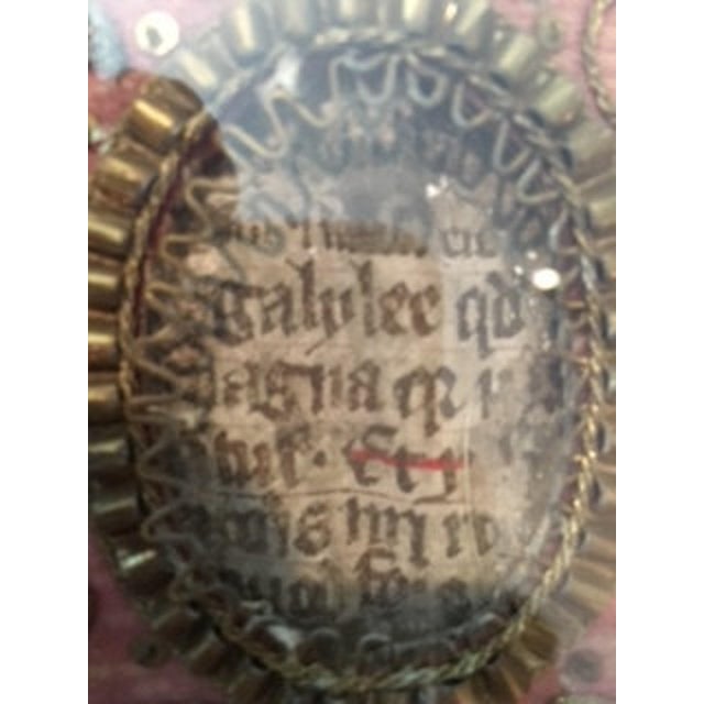 An 18th-century Austrian reliquary cloth — 15"W x 17.5"H — worked in gold thread and embroidery, with inscribed parchment...