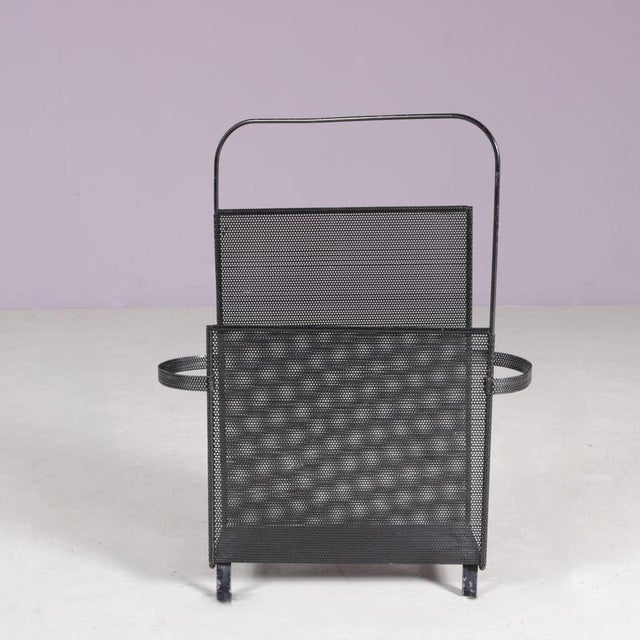 1950s magazine rack designed by Mathieu Matégot for Artimeta, Netherlands. A refined example of mid-century modern design,...