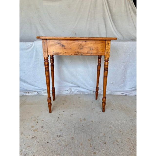 This 19th Century English Pine Federal Style Side Table dates back to the late 1800's. The piece features planked top,...