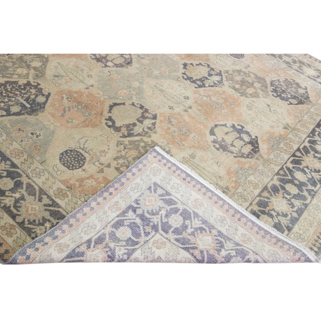 Beautiful vintage Sivas hand-knotted wool rug with a beige field. This Turkish piece has a gray designed frame and peach,...