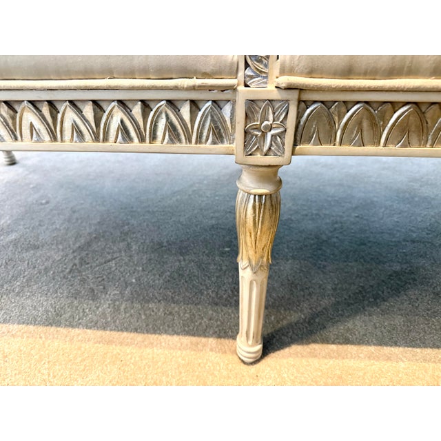 Elegant French carved chaise with crisp neoclassical lines, newly upholstered in silk that highlights the finely detailed,...