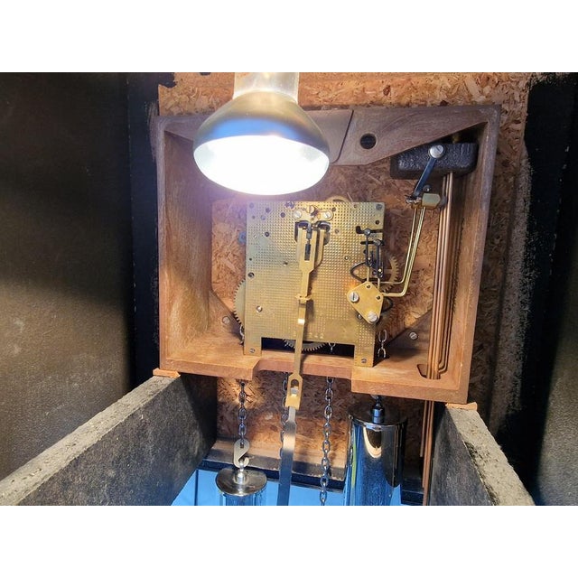 Vintage sculpted brutalist design grandfather clock made from resin and wood. The clock is illuminated on the inside and...