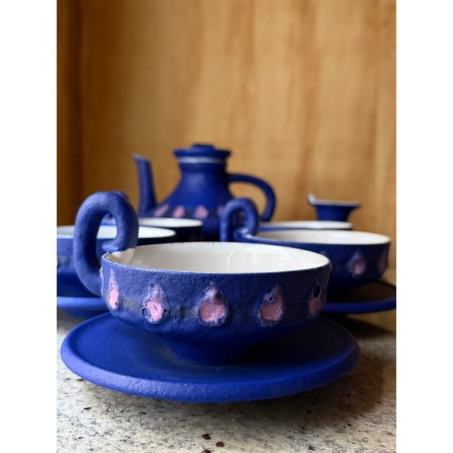 A distinctive vintage ceramic coffee set by HOY, characterized by its expressive sculptural forms and deep cobalt blue...