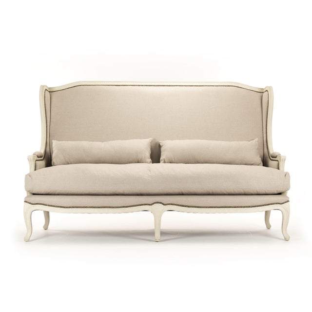 The Leon Bench from Zentique scales the dramatic wingback bergère to settee/sofa proportions. The tall scalloped back,...