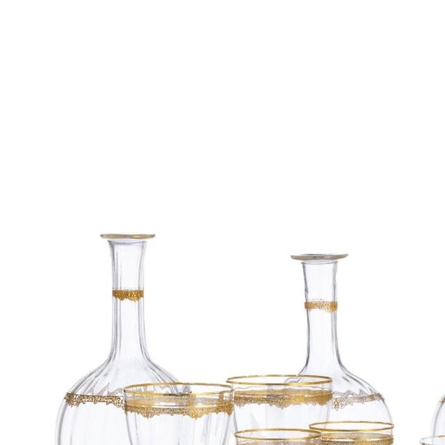 Glass and Crystal - Glassware Service. 20th-century Portuguese, in molded crystal, gold-engraved decoration, comprising:...