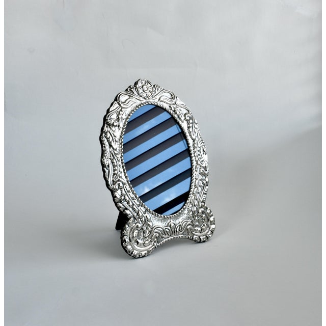 This exquisite vintage Large frame is crafted from 925 sterling silver and features a wide border of intricate repousse...