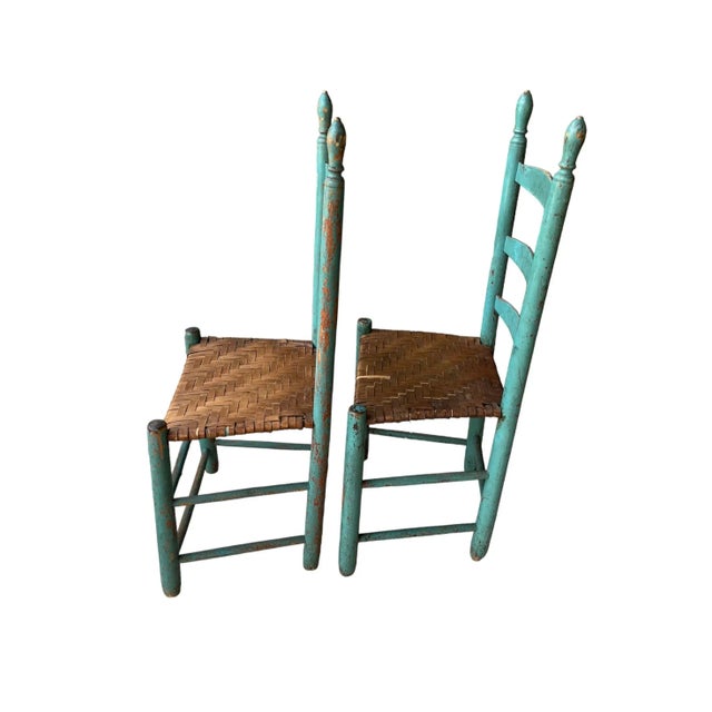 A Pair of Primitive Ladderback Chairs featuring woven seats and beautifully aged Turquoise.. Sturdy, in very good condition.