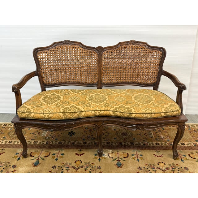 Design Plus Gallery presents a French Cane Back Sofa Bench from the 20th Century. The leg, arms and back rest have...
