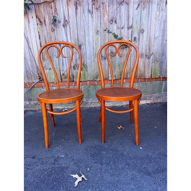 Pair of Bistro Style Bentwood Dining Chairs Made in Romania Good condition with age. Approximate measures: 19'' deep,...