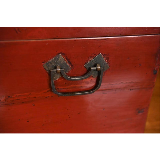 An antique Chinese red lacquered table top-sized wooden chest, likely a lady's dressing or cosmetic box, with a hinged...