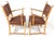 A fabulous pair of carved oak Danish Modern armchairs with leather upholstery and tacking accents. The chairs, while...