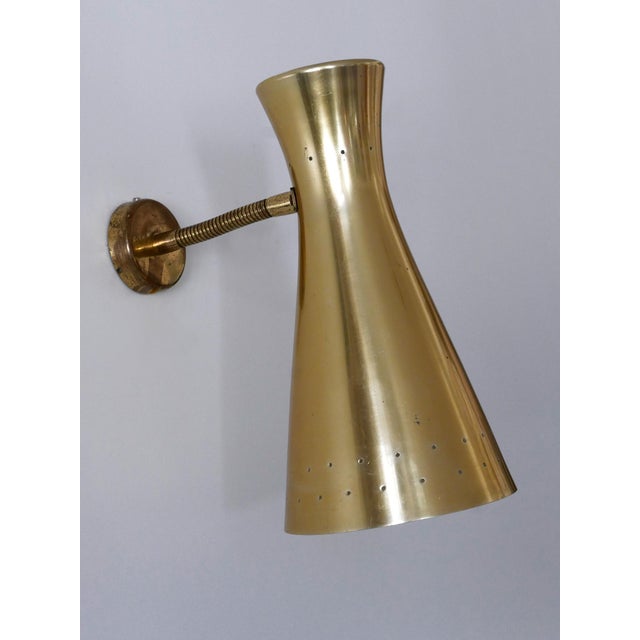 Lovely and highly decorative mid-century modern diabolo wall lamp or sconce with goosneck arm. Designed and manufactured...