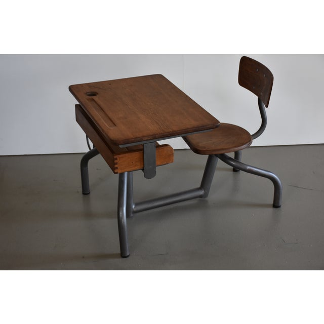 Original school desk from France, 1930s design. The school desk, with its tubular steel frame connecting the desk to the...
