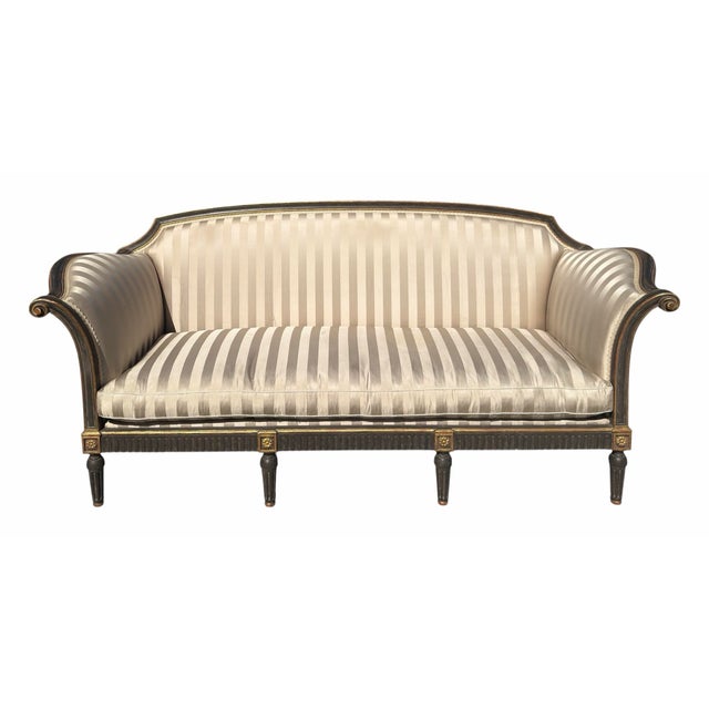 Dennis and Leen Ebonized and Giltwood Settee with silk stripe upholstery.