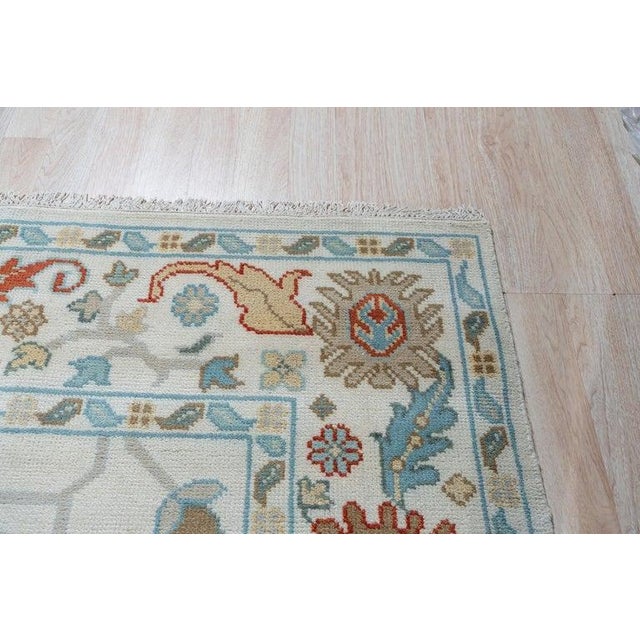 This EORC Rugs product is a hand knotted pile rug crafted from wool featuring a primary color palette of ivory, beige,...
