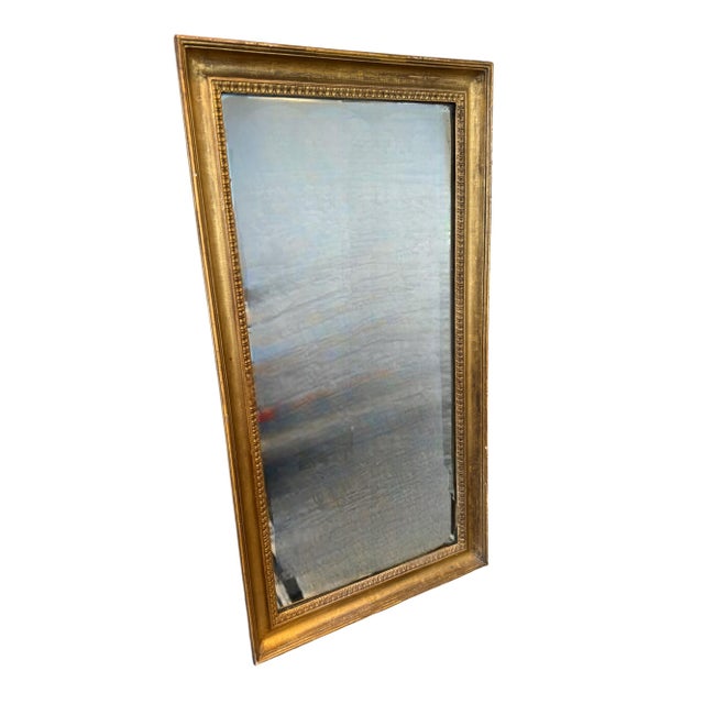 Dims: 29.5”W x 3”D x 56.5”H Frame: 3”W Mirror: Antique Glass Mounting: Vertical Antique French gilt wall mirror, featuring...