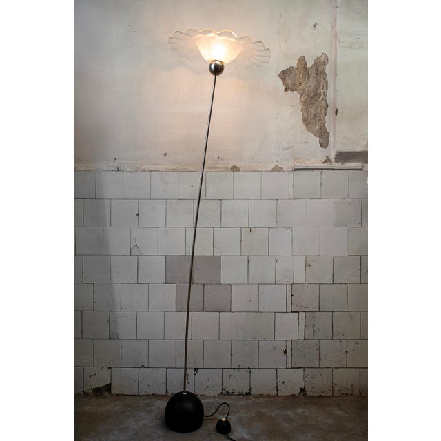 Floor lamp with cast iron base, chromed metal stem, and Murano glass diffuser. Farfallone model Designer Toni Zuccheri...