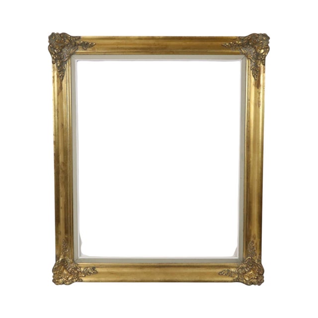 Vintage gold-colored pine frame featuring acanthus and floral ornamentation in a classic Baroque style; the piece boasts a...